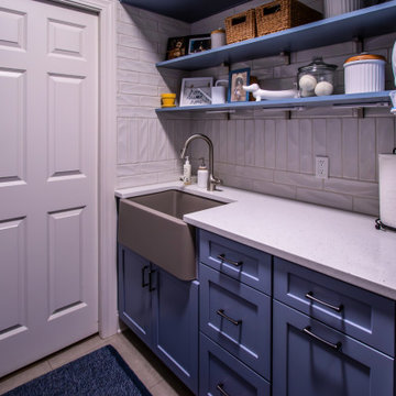 Laundry Room with Blue Painted Cabinetry and Sparkling White Quartz Countertops