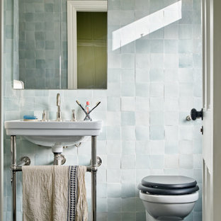 Inspiration for a small classic ensuite bathroom in London with a walk-in shower, a wall mounted toilet, blue tiles, porcelain tiles, blue walls, marble flooring, a pedestal sink, black floors, an open shower, a wall niche, a single sink and a freestanding vanity unit.