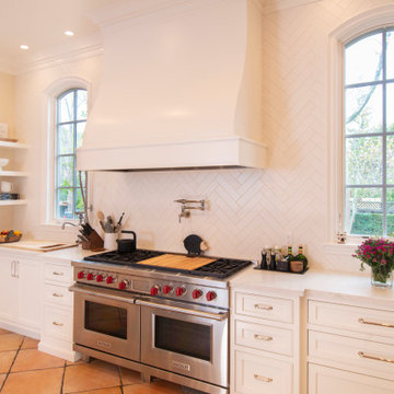 A Full Overlay, Custom-Built Kitchen Hood Anchors the Space