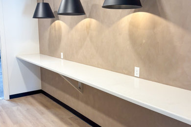 Home office - large modern light wood floor and beige floor home office idea in Houston