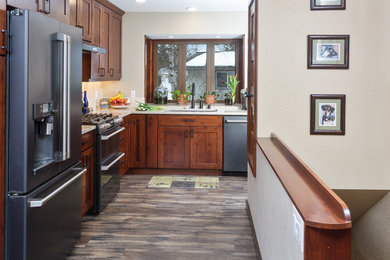 Inspiration for a mid-sized transitional u-shaped vinyl floor and gray floor kitchen pantry remodel in Other with a single-bowl sink, shaker cabinets, medium tone wood cabinets, quartz countertops, beige backsplash, stone tile backsplash, black appliances, no island and beige countertops