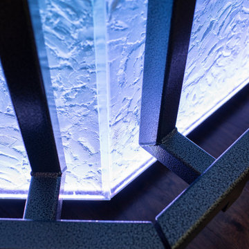 Glass private bar and glass stair treads inside a man cave in Michigan