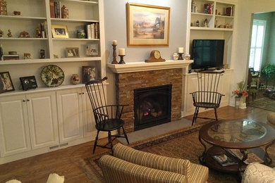 Photo of a living room in Boston with a stone fireplace surround.