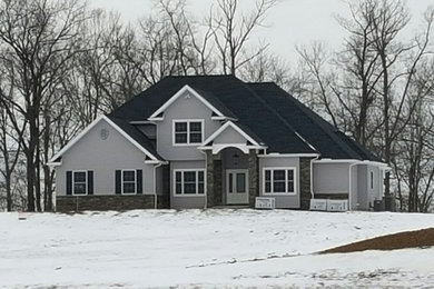 Example of a large arts and crafts gray two-story mixed siding exterior home design in Other with a shingle roof