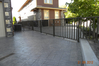 Example of a huge trendy backyard deck design in Calgary with no cover