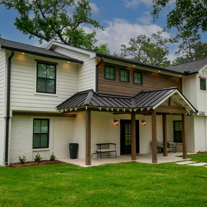 This was a full exterior rebuild due to 1 tree falling on the house and a second tree falling on the garage.  The exterior features 4 different types of siding including prefinished stained siding by