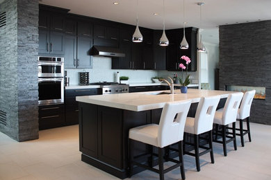 Mid-sized trendy l-shaped porcelain tile open concept kitchen photo in Providence with an undermount sink, shaker cabinets, black cabinets, marble countertops, mosaic tile backsplash, stainless steel appliances and an island