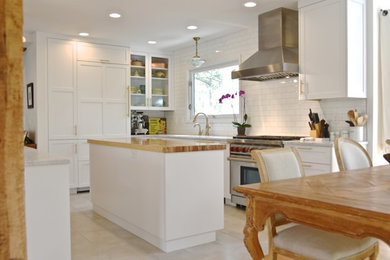 Photo of a small traditional u-shaped eat-in kitchen in Denver with a single-bowl sink, shaker cabinets, white cabinets, marble benchtops, white splashback, ceramic splashback, stainless steel appliances, porcelain floors, with island, grey floor and white benchtop.