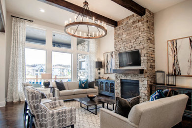 Family room - large traditional open concept dark wood floor family room idea in Kansas City with white walls, a standard fireplace, a stone fireplace and a wall-mounted tv