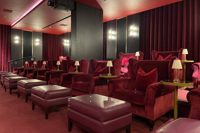 Design ideas for a large traditional home cinema in London with red walls, carpet, a projector screen, red floors and feature lighting.
