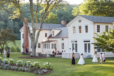 Inspiration for a large timeless white three-story wood house exterior remodel