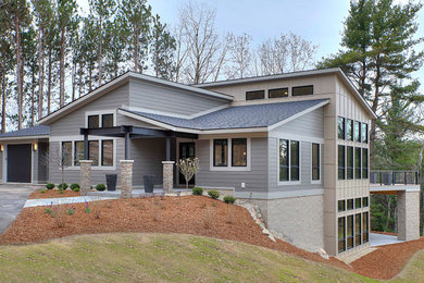 Mid-sized transitional one-storey exterior in Other with mixed siding.