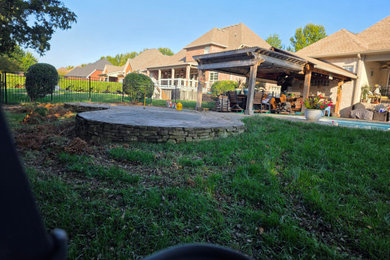 Example of a mid-sized classic backyard concrete patio design in Nashville with a bbq area and no cover