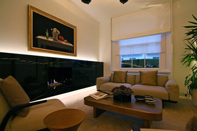Medium sized modern open plan living room in London with white walls, light hardwood flooring, a hanging fireplace, a stone fireplace surround and grey floors.