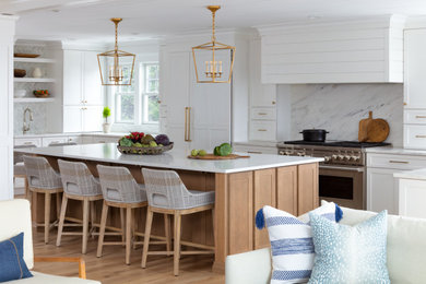 This is an example of a large beach style u-shaped open plan kitchen in Boston with with island.