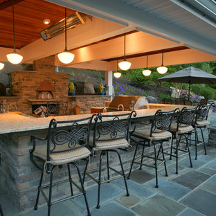 Outdoor kitchen deck - large traditional backyard outdoor kitchen deck idea in DC Metro with a roof extension