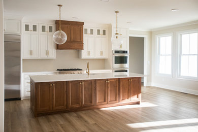 Inspiration for a transitional single-wall open concept kitchen remodel in Raleigh with shaker cabinets, white cabinets, quartz countertops, an island and white countertops
