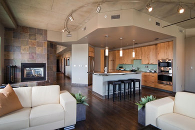 Open concept kitchen - large rustic single-wall dark wood floor and brown floor open concept kitchen idea in Denver with flat-panel cabinets, medium tone wood cabinets, stainless steel countertops, blue backsplash, stainless steel appliances, an island and ceramic backsplash