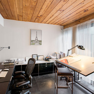 Medium sized modern study in New York with white walls, slate flooring, no fireplace, a built-in desk and grey floors.