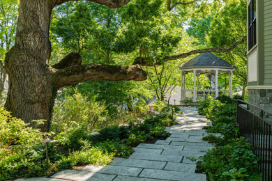 Inspiration for a transitional shade backyard stone landscaping in Boston.
