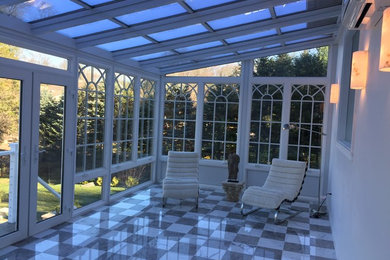 Inspiration for a large traditional sunroom in Boston with ceramic floors and a glass ceiling.
