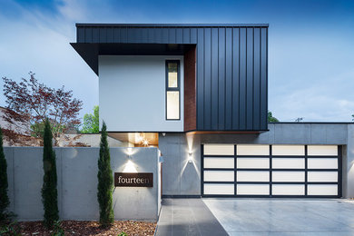 Design ideas for a modern two-storey grey house exterior in Canberra - Queanbeyan with metal siding, a flat roof and a mixed roof.