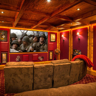 This is an example of a medium sized rustic enclosed home cinema in Huntington with red walls, carpet, a projector screen and multi-coloured floors.