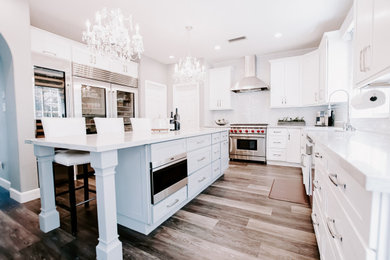 Inspiration for a huge modern eat-in kitchen remodel in San Diego with shaker cabinets, quartzite countertops, white backsplash, glass tile backsplash, stainless steel appliances, an island and gray countertops