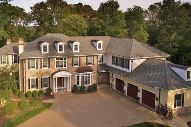 Huge elegant beige three-story mixed siding house exterior photo in New York with a hip roof and a shingle roof