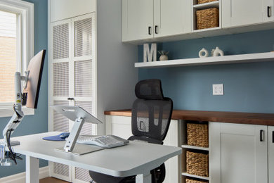 Example of a transitional home office design in Toronto