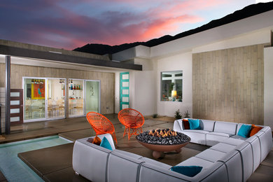 Mid-century modern patio photo in Los Angeles with a fire pit and no cover
