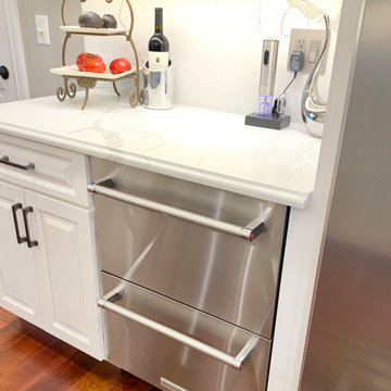 Ivory White Kitchen With Marble Look Quartz Counters and Splash