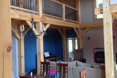 Inspiration for a mid-sized rustic light wood floor and beige floor great room remodel in Other with gray walls and a standard fireplace