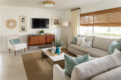 This is an example of a transitional family room in Orlando with beige walls, no fireplace and a wall-mounted tv.