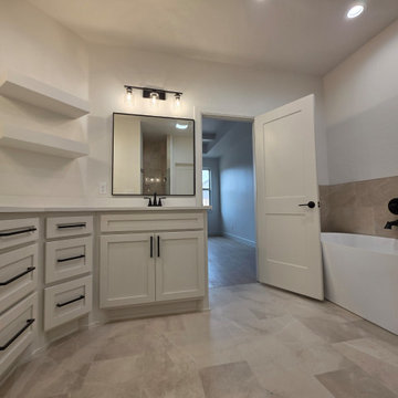 Primary/Master Bath offers a soaking tub and double vanity surrounding the corne