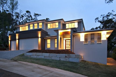 Design ideas for a large modern split-level beige exterior in Brisbane.