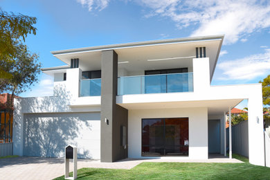 Photo of a mid-sized contemporary two-storey brick white house exterior in Perth with a metal roof.