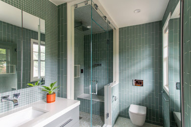 Inspiration for a mid-sized modern master green tile and glass tile mosaic tile floor, multicolored floor and single-sink bathroom remodel in New York with flat-panel cabinets, gray cabinets, a wall-mount toilet, green walls, an undermount sink, quartz countertops, a hinged shower door, white countertops and a freestanding vanity