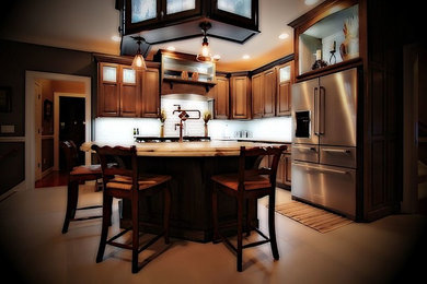 Example of an arts and crafts beige floor eat-in kitchen design in Other with brown cabinets, white backsplash, stainless steel appliances, an island and beige countertops