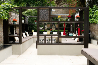 Medium sized world-inspired back formal fully shaded garden in London.