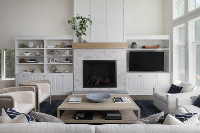 Beach style dark wood floor and brown floor living room photo in Milwaukee with gray walls, a standard fireplace, a tile fireplace and a wall-mounted tv