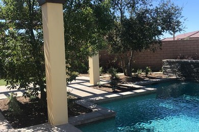 Inspiration for an expansive back formal full sun garden for spring in Orange County with a water feature and brick paving.