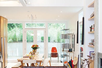 Example of a mid-sized transitional open concept medium tone wood floor and brown floor living room design in Chicago with white walls, a standard fireplace, a tile fireplace and a wall-mounted tv
