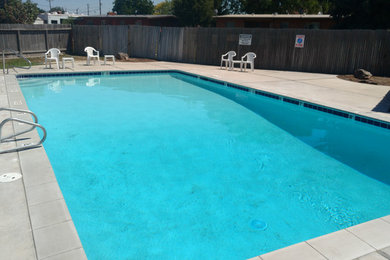 Design ideas for a mid-sized courtyard rectangular pool in Boise with concrete slab.