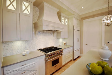 Inspiration for a large transitional galley light wood floor open concept kitchen remodel in Vancouver with a double-bowl sink, recessed-panel cabinets, white cabinets, quartzite countertops, white backsplash, marble backsplash, paneled appliances and an island
