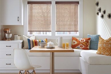 Large transitional light wood floor eat-in kitchen photo in Other with flat-panel cabinets, white cabinets and solid surface countertops