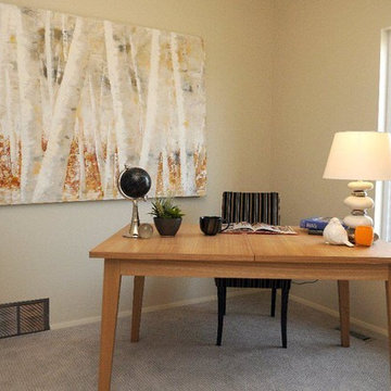 Contemporary show home with orange accessories.