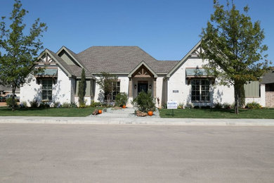 Large transitional white two-story concrete fiberboard house exterior photo in Orange County with a clipped gable roof and a shingle roof