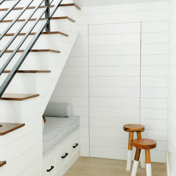 Coastal modern farmhouse stairwell nook bench hidden shiplap door