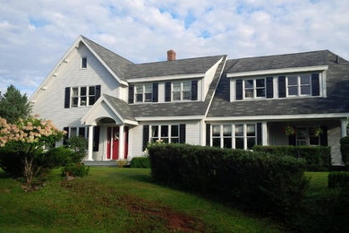 Inspiration for a mid-sized timeless gray two-story wood house exterior remodel in Other with a hip roof and a shingle roof